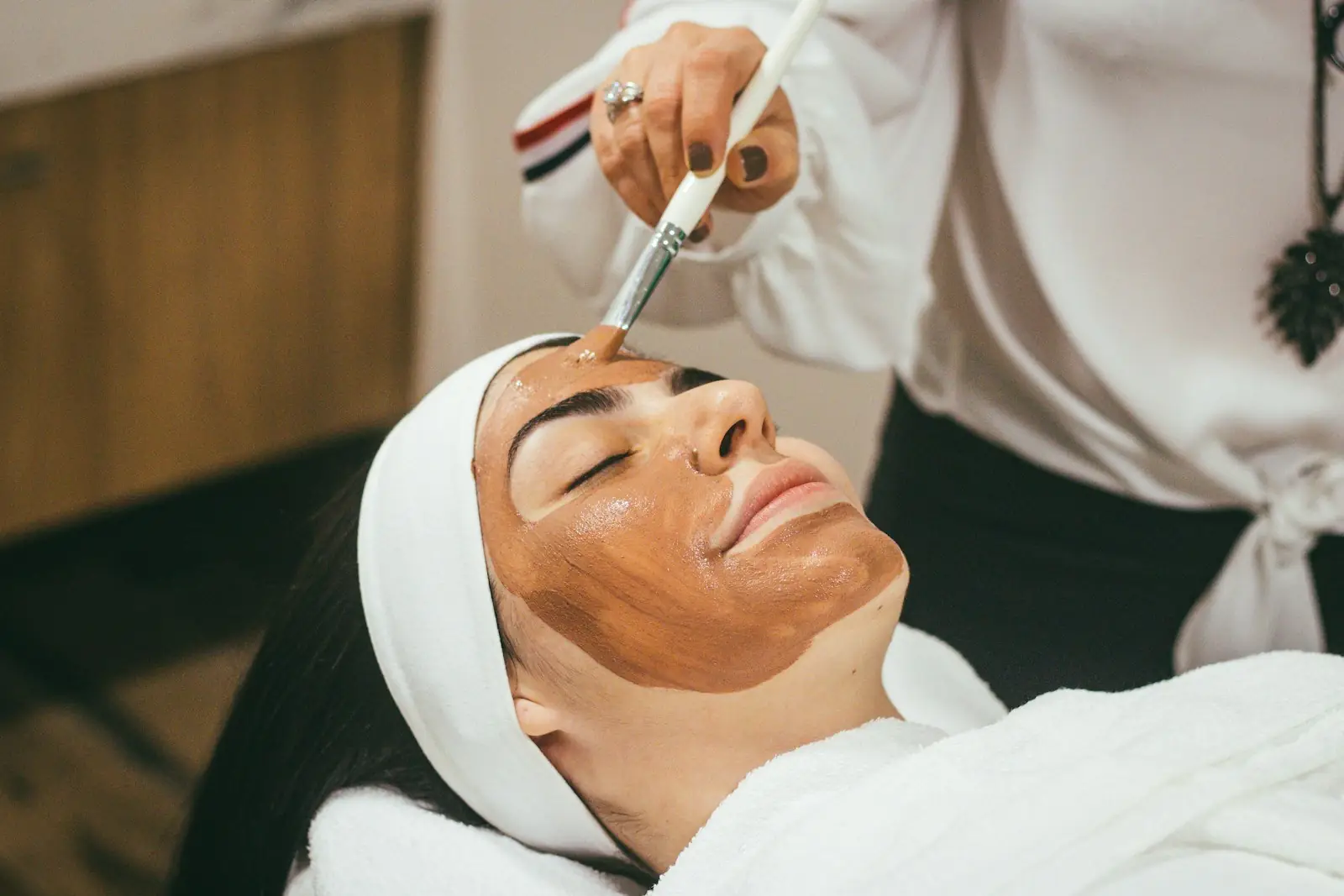 Client relaxing during a facial treatment