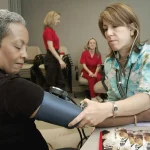 Clinician checking a patient’s blood pressure