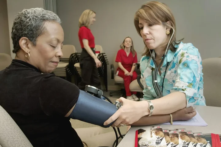 Clinician checking a patient’s blood pressure