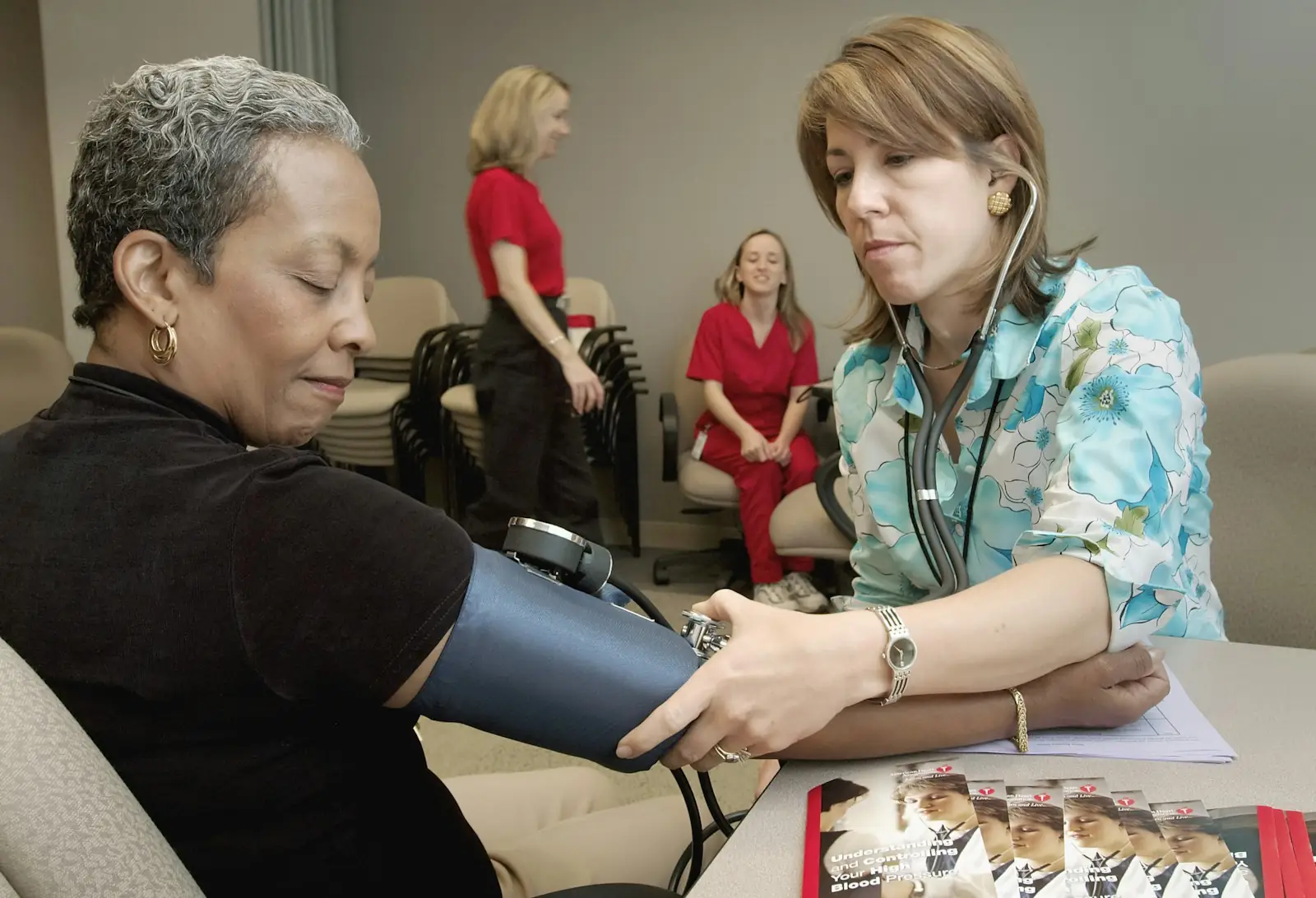 Clinician checking a patient’s blood pressure