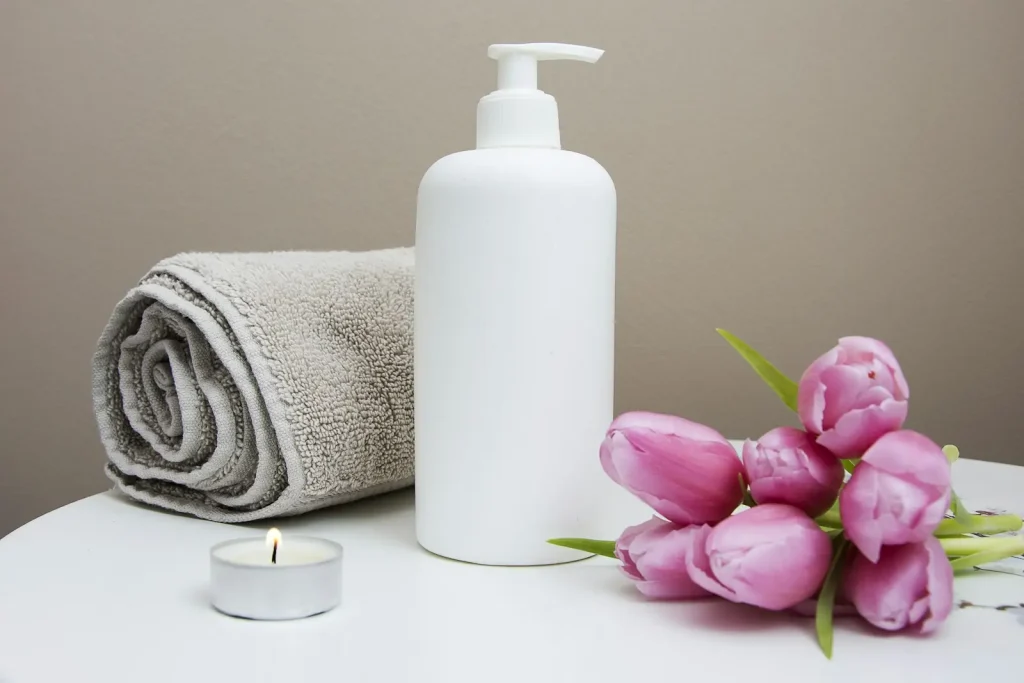 Skincare products and a folded towel